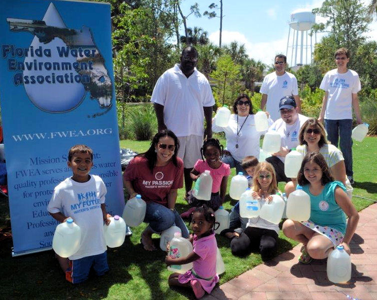 Walk for Water challenge participants included both children and adults who walked 0.4 km (0.25 mi) carrying 7.6-L (2-gal) jugs of water to learn about and raise awareness for what women and children in developing countries do daily for their water supply. Photo courtesy of Greg Chomic, Florida Water Environment Association.