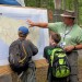 Water Environment Federation (WEF; Alexandria, Va.) volunteer at the 2013 National Scout Jamboree, John Hughes from Infilco-Degremont Technologies (Richmond, Va.) explains the water resource map and shows two Scouts their hometown watersheds. WEF photo/Steve Harrison.