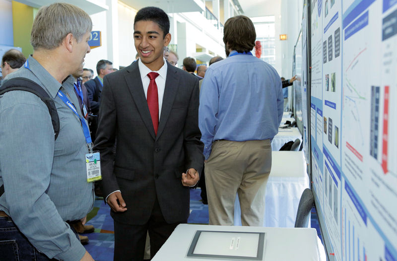 Anirudh Jain, the 2013 U.S. Stockholm Junior Water Prize (SJWP) winner, talks with a WEFTEC 2013 attendee in front of his poster. The poster describes Jain's award-winning project, “Sulfidation as a Novel Method To Reduce Toxicity of Silver Nanoparticle Pollution.” Photo courtesy of Oscar Einzig photography.