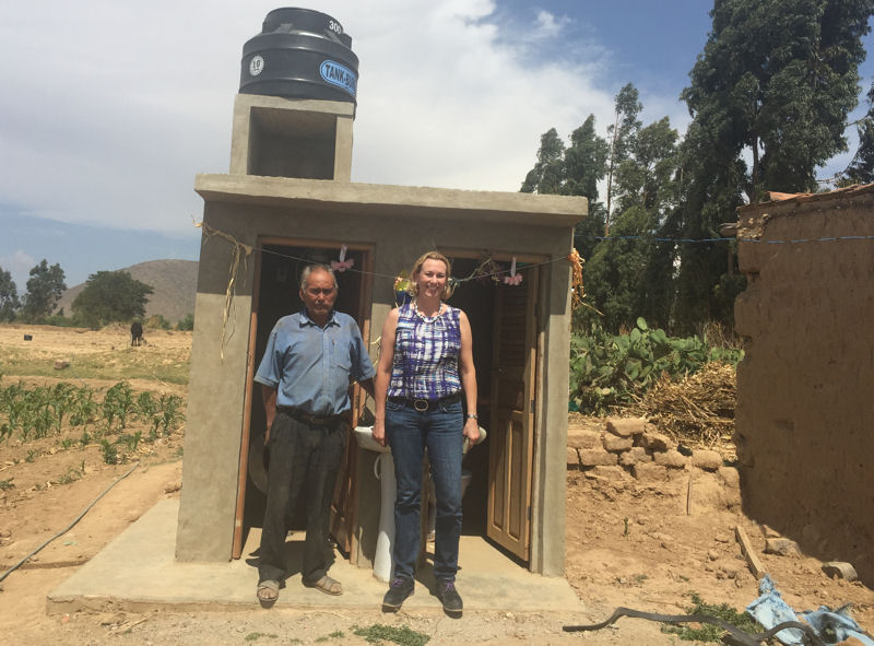 Eleanor Allen (right), the new CEO of Water For People (Denver), stands with Don Pedro in front of his new toilet and shower. Photo courtesy of Allen.