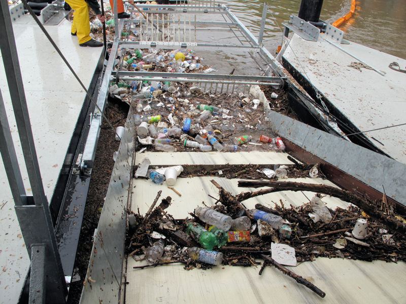 A team uses webcams to monitor the wheel and its trash collection. Collected trash falls into a dumpster sitting on a barge inside the system. Photo courtesy of the Waterfront Partnership of Baltimore.