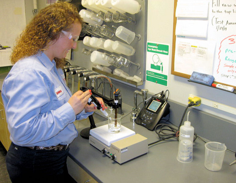 Dawna Laetzsch, graduate from LBCC with a degree in water, environment, and technology, tests a water sample at the water treatment facility in Wilsonville, Ore., where she works as a water treatment technician. Photo courtesy of the LBCC Advancement Office. 