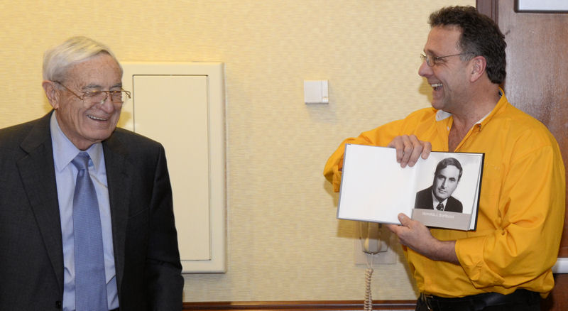 Koester (right) shows a headshot of Bartilucci (left) to those gathered to honor Bartilucci during the meeting. Photo courtesy of Skibinski.