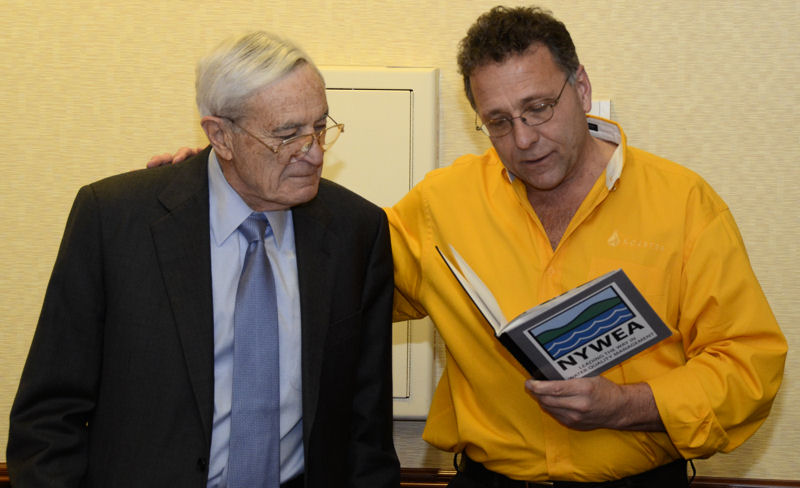 Koester presents Bartilucci with a book filled with photos and text that recognize Bartilucci’s work for and commitment to NYWEA. Photo courtesy of Skibinski.