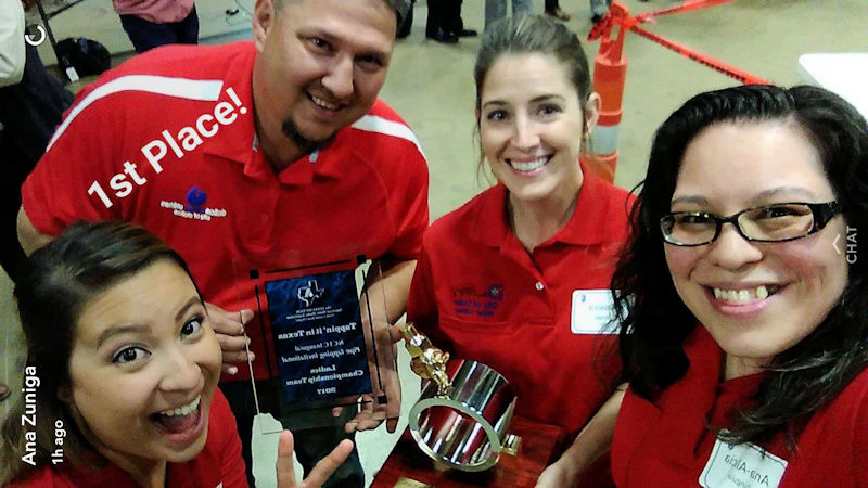 From left, members of the Big D Lady Tappers Jessica, coach Adam Hewitt, Jessica Staggs, and Ana-Alicia Zuñiga hold their first place award form the North Texas Annual Invitational Competition 2017. Photo courtesy of Ana-Alicia Zuñiga.