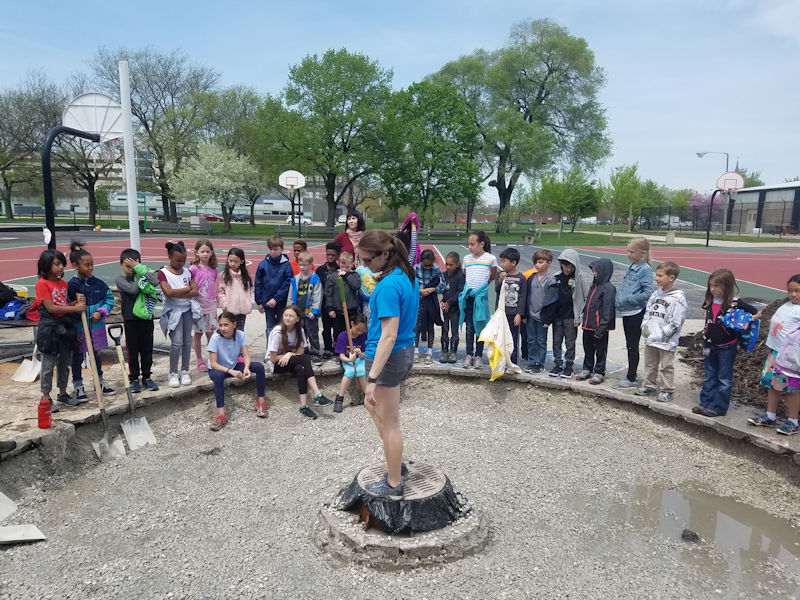 During the Central States Water Environment Association (CSWEA) first Service Project at the Skinner North Classical School (Chicago), volunteer Natalie Cook explains stormwater and green infrastructure to students. Photo courtesy of Katherine Magnuson.
