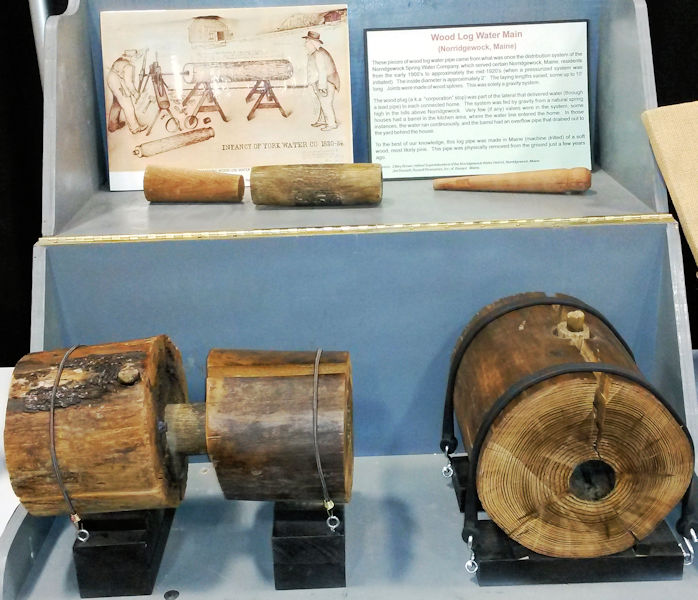 This portion of the Sewer History Exhibit shows early wood pipes used to distribute water. An informational sign provides background about the process. Photo courtesy of David A. Hofer. 